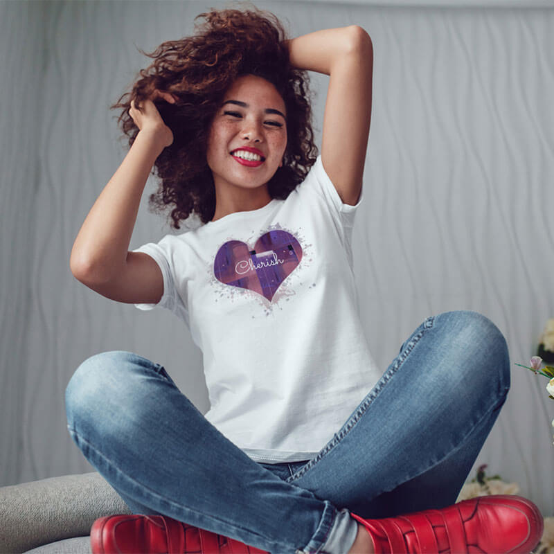 Woman smiling wearing a white Love is in the Heart - Cherish t-shirt.